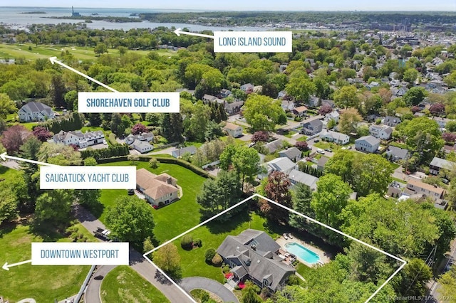 aerial view of residential area with property boundaries highlighted, a pool, and a large body of water
