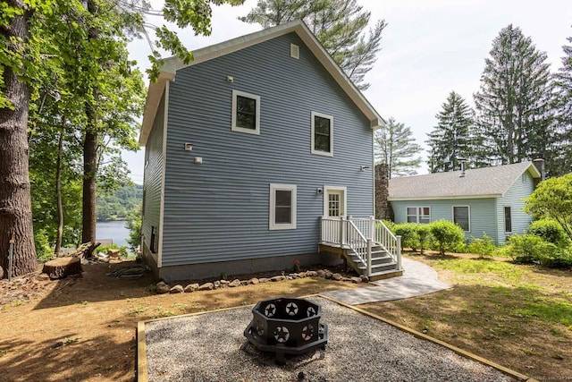 rear view of house featuring a fire pit