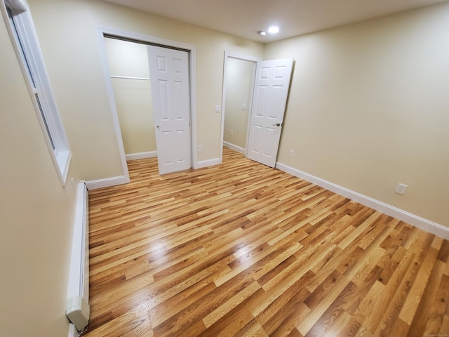 unfurnished bedroom with recessed lighting, baseboards, and light wood-style floors