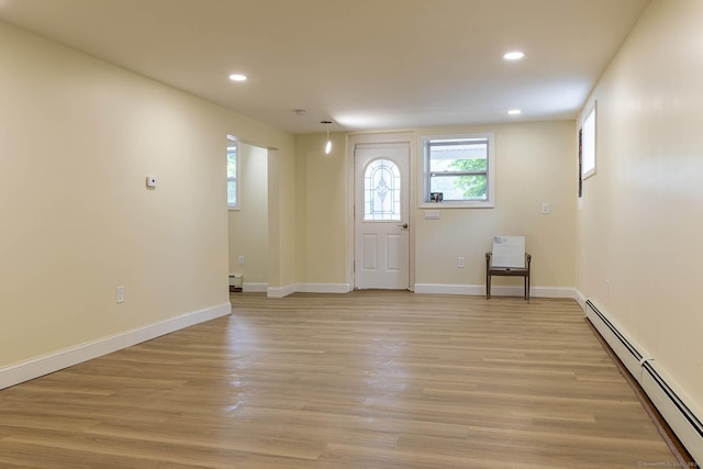 foyer entrance featuring recessed lighting, light wood-style flooring, and a baseboard radiator