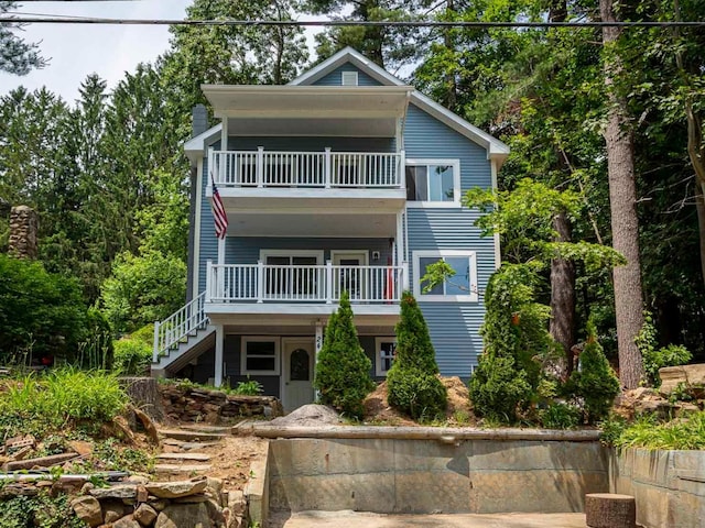view of front of home featuring stairway and a balcony