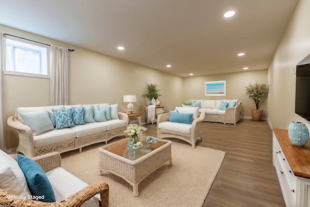 living room featuring wood finished floors, recessed lighting, and baseboards