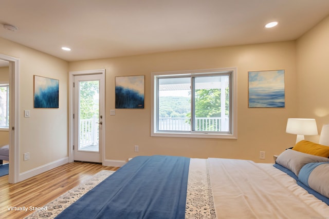 bedroom with baseboards, recessed lighting, access to exterior, and wood finished floors