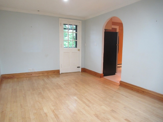 164 Flanders St, Bridgeport, CT 06604 - empty room with ornamental molding, light wood-style flooring, baseboards, and arched walkways
