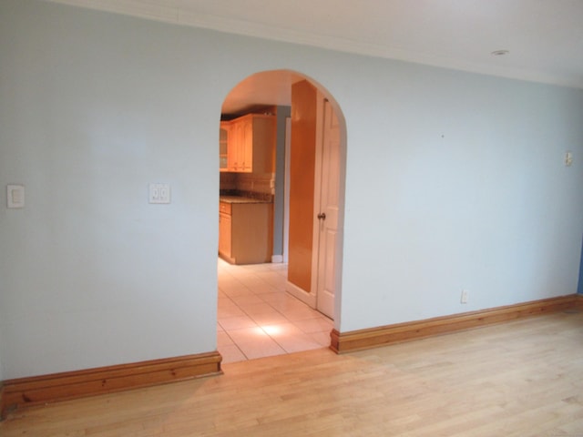 164 Flanders St, Bridgeport, CT 06604 - spare room with arched walkways, light wood finished floors, crown molding, and baseboards