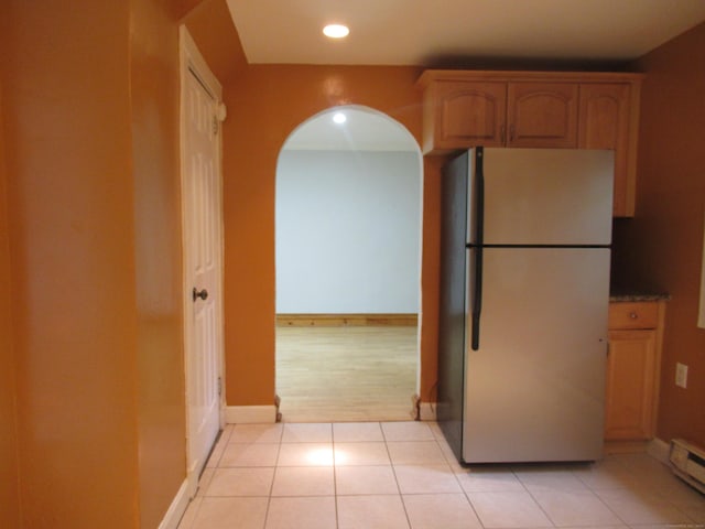 164 Flanders St, Bridgeport, CT 06604 - kitchen with freestanding refrigerator, arched walkways, recessed lighting, a baseboard radiator, and light tile patterned floors