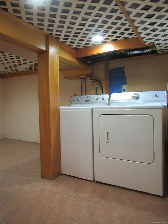 164 Flanders St, Bridgeport, CT 06604 - washroom with washer and dryer and light tile patterned flooring