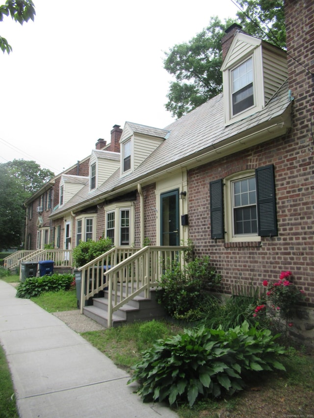 164 Flanders St, Bridgeport, CT 06604 - view of front of house featuring brick siding and a chimney