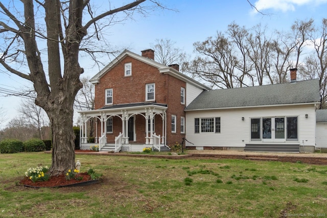 280 Mill Rd, North Haven, CT 06473 - view of front of home with a porch, a chimney, a front lawn, and brick siding