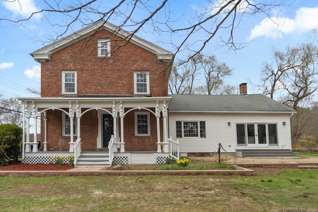 280 Mill Rd, North Haven, CT 06473 - rear view of property featuring brick siding, covered porch, a chimney, and a lawn