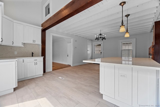 280 Mill Rd, North Haven, CT 06473 - kitchen featuring beam ceiling, a chandelier, white cabinets, light countertops, and hanging light fixtures
