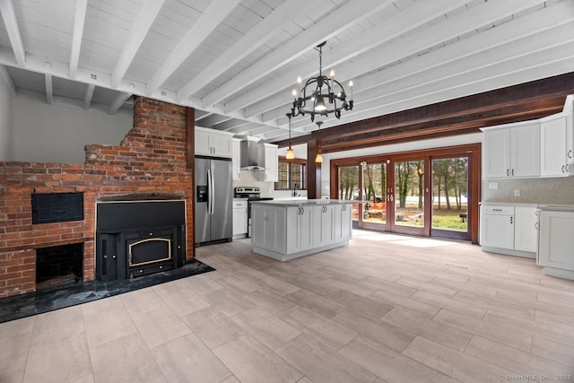 280 Mill Rd, North Haven, CT 06473 - kitchen featuring stainless steel appliances, wall chimney range hood, a fireplace, beamed ceiling, and a chandelier