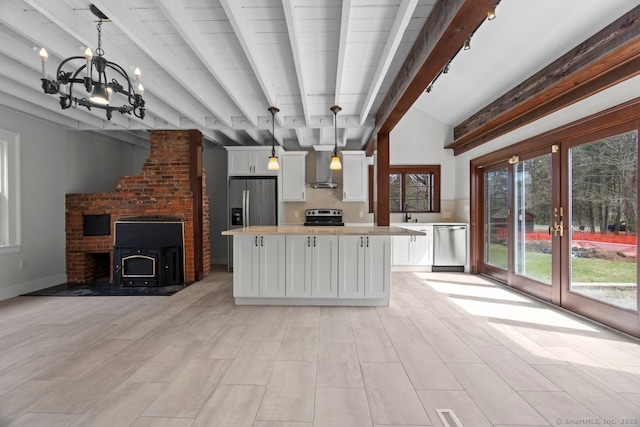 280 Mill Rd, North Haven, CT 06473 - kitchen with appliances with stainless steel finishes, light countertops, a chandelier, white cabinetry, and french doors