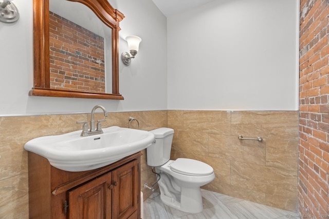 280 Mill Rd, North Haven, CT 06473 - bathroom featuring tile walls, toilet, wainscoting, vanity, and tile patterned flooring