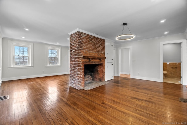 280 Mill Rd, North Haven, CT 06473 - unfurnished living room featuring crown molding, wood-type flooring, a brick fireplace, baseboards, and recessed lighting