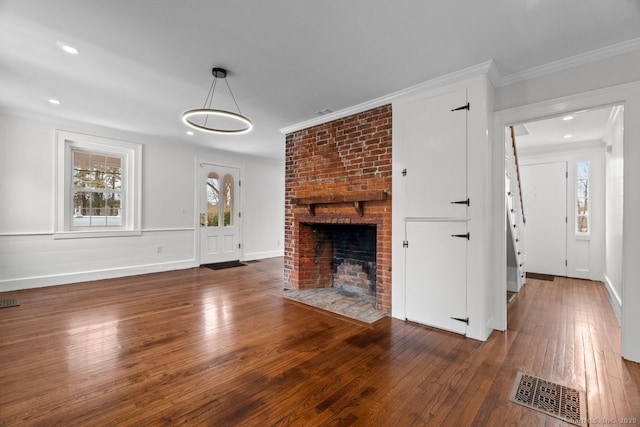 280 Mill Rd, North Haven, CT 06473 - unfurnished living room with wood-type flooring, a brick fireplace, and ornamental molding