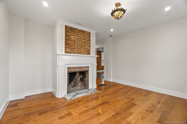 280 Mill Rd, North Haven, CT 06473 - unfurnished living room featuring a brick fireplace, baseboards, light wood-type flooring, and recessed lighting