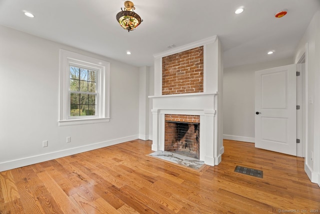 280 Mill Rd, North Haven, CT 06473 - unfurnished living room with a brick fireplace, wood finished floors, baseboards, and recessed lighting