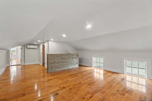 280 Mill Rd, North Haven, CT 06473 - bonus room with light wood finished floors, an AC wall unit, vaulted ceiling, and baseboards