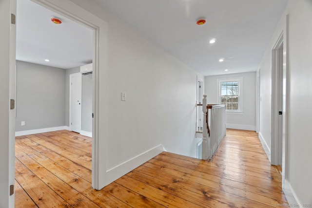 280 Mill Rd, North Haven, CT 06473 - hallway with an upstairs landing, an AC wall unit, baseboards, light wood-style floors, and recessed lighting