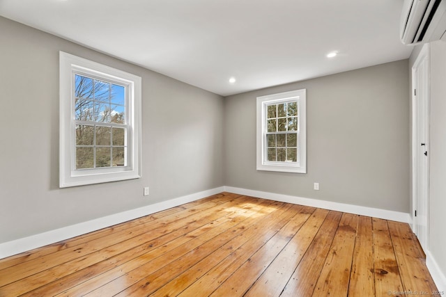 280 Mill Rd, North Haven, CT 06473 - empty room featuring a wall unit AC, hardwood / wood-style floors, baseboards, and recessed lighting