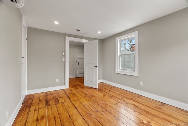 280 Mill Rd, North Haven, CT 06473 - empty room with a wall mounted air conditioner, recessed lighting, baseboards, and hardwood / wood-style floors