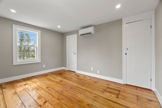280 Mill Rd, North Haven, CT 06473 - unfurnished room featuring an AC wall unit, baseboards, recessed lighting, and light wood finished floors