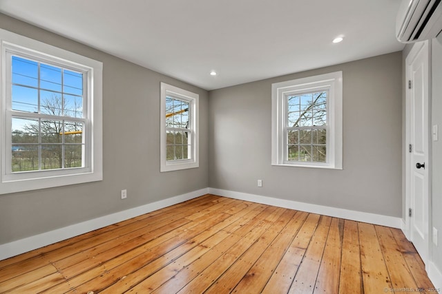 280 Mill Rd, North Haven, CT 06473 - spare room featuring a wall mounted air conditioner, hardwood / wood-style flooring, baseboards, and recessed lighting