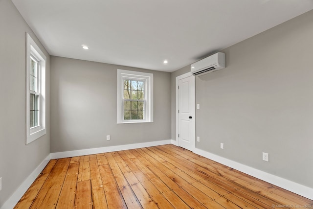 280 Mill Rd, North Haven, CT 06473 - unfurnished room with a wall unit AC, hardwood / wood-style flooring, baseboards, and recessed lighting