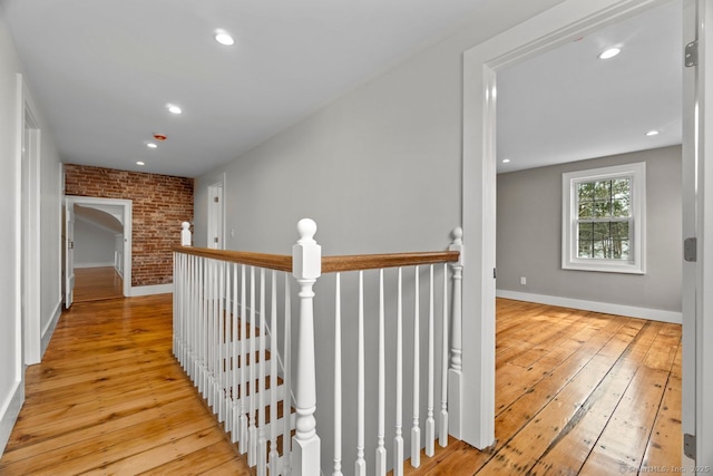 280 Mill Rd, North Haven, CT 06473 - hall featuring an upstairs landing, hardwood / wood-style floors, baseboards, recessed lighting, and brick wall