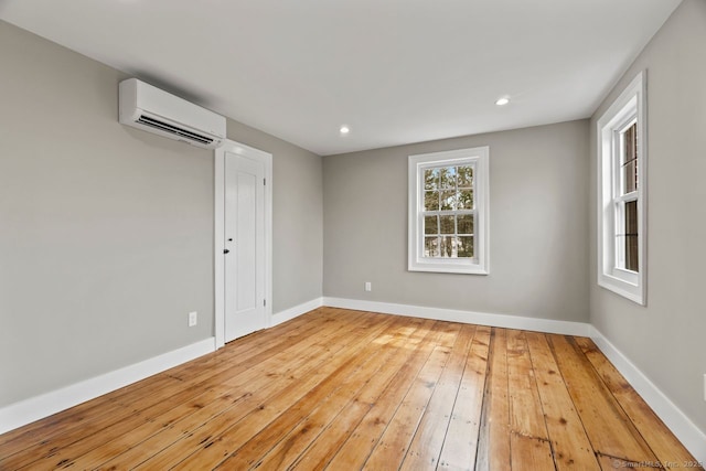 280 Mill Rd, North Haven, CT 06473 - unfurnished room featuring a wall mounted AC, hardwood / wood-style floors, baseboards, and recessed lighting
