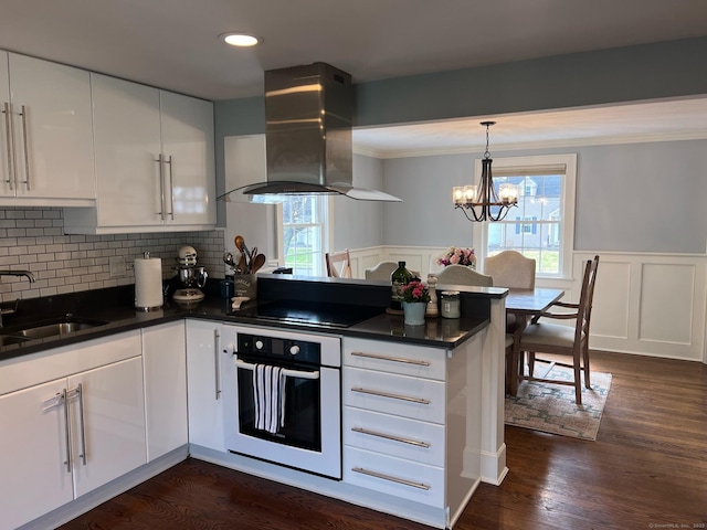 90 Bentwood Rd, West Hartford, CT 06107 - kitchen featuring oven, a sink, dark countertops, black electric stovetop, and extractor fan