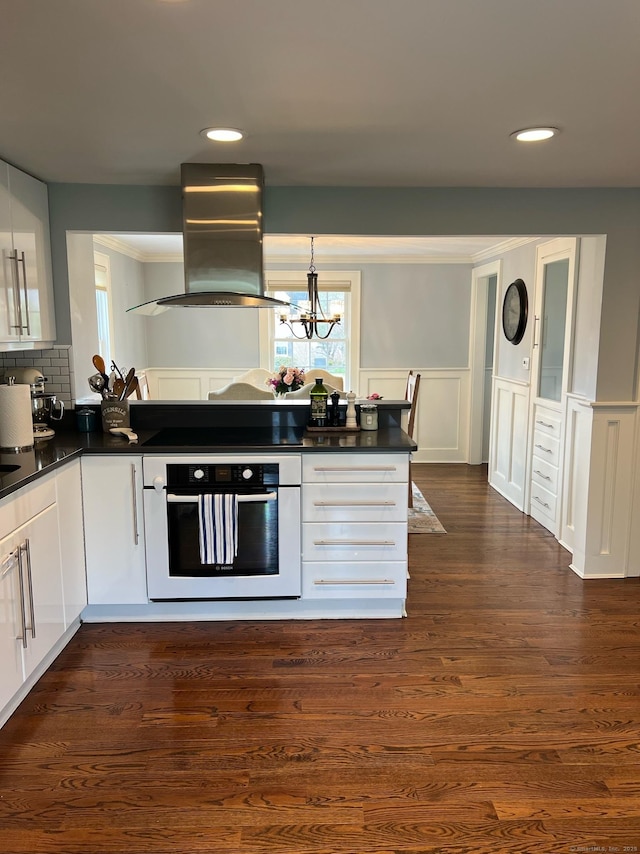 90 Bentwood Rd, West Hartford, CT 06107 - kitchen featuring cooktop, dark countertops, wall oven, and island exhaust hood