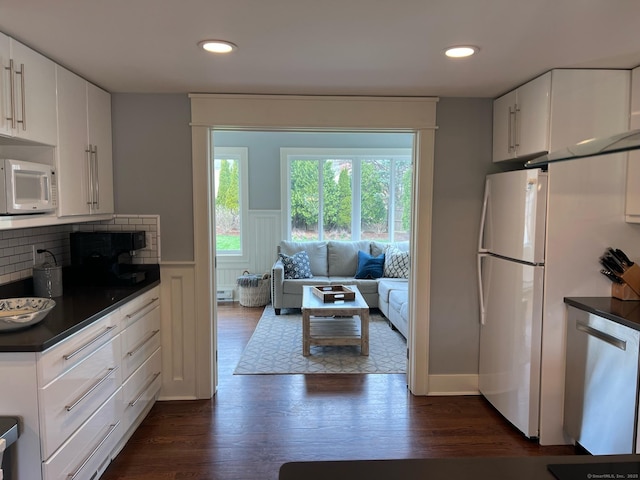 90 Bentwood Rd, West Hartford, CT 06107 - kitchen featuring white appliances, backsplash, dark countertops, white cabinets, and dark wood finished floors