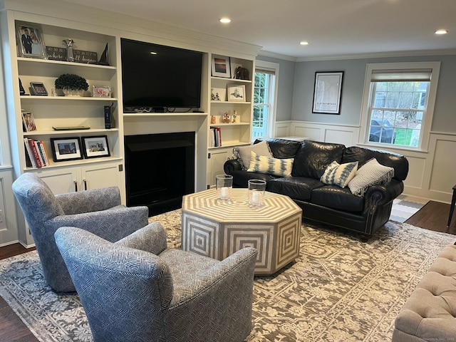 90 Bentwood Rd, West Hartford, CT 06107 - living area with crown molding, wainscoting, wood finished floors, and a fireplace