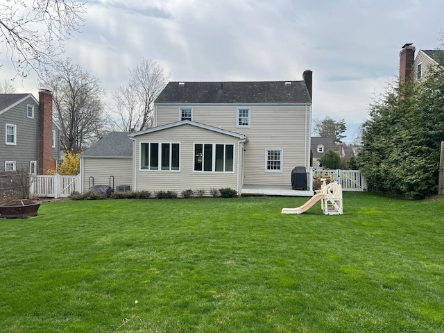 90 Bentwood Rd, West Hartford, CT 06107 - back of house featuring an outdoor fire pit, fence, and a lawn