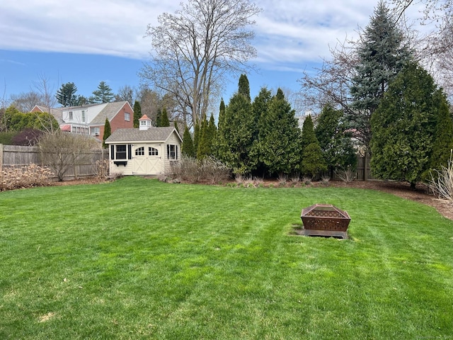 90 Bentwood Rd, West Hartford, CT 06107 - view of yard featuring a fenced backyard, an outdoor structure, a fire pit, and a storage unit