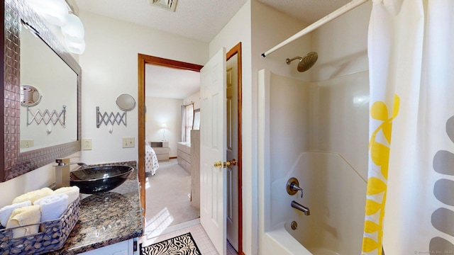 ensuite bathroom featuring connected bathroom, vanity, visible vents, shower / tub combo with curtain, and tile patterned floors