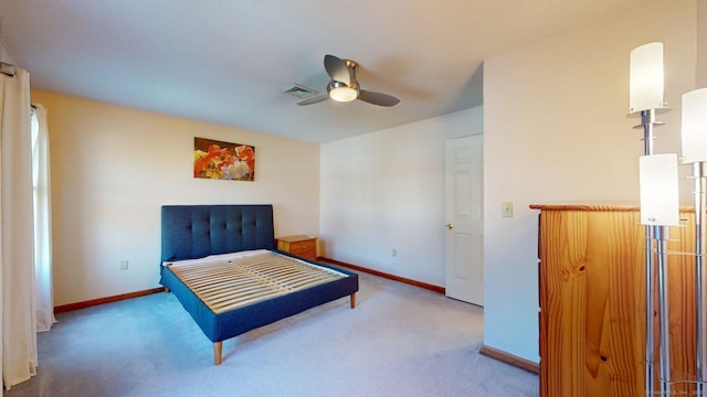 carpeted bedroom with visible vents, baseboards, and a ceiling fan