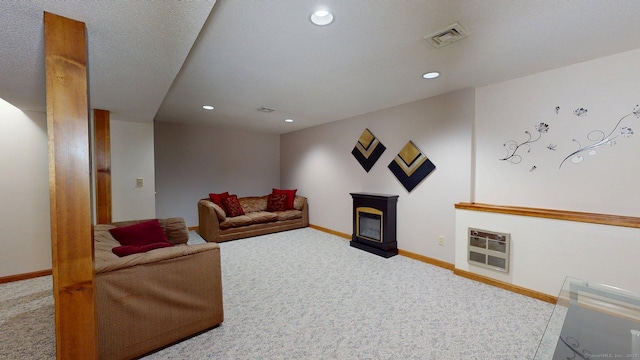 living room with recessed lighting, carpet flooring, visible vents, and heating unit