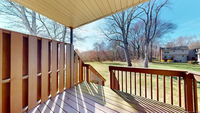 wooden terrace featuring a yard