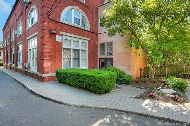 32 Pine St Unit 6, Norwalk, CT 06854 - view of building exterior featuring fence and cooling unit