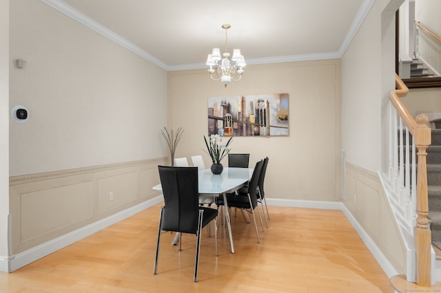 19 Mill Rd Unit 19, Danbury, CT 06810 - dining area featuring stairway, ornamental molding, a decorative wall, light wood-style flooring, and a notable chandelier