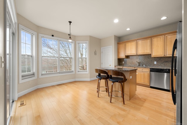 19 Mill Rd Unit 19, Danbury, CT 06810 - kitchen featuring backsplash, baseboards, appliances with stainless steel finishes, and a kitchen island