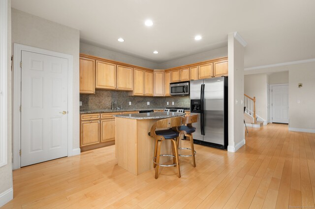 19 Mill Rd Unit 19, Danbury, CT 06810 - kitchen with recessed lighting, a kitchen island, a kitchen bar, tasteful backsplash, and appliances with stainless steel finishes