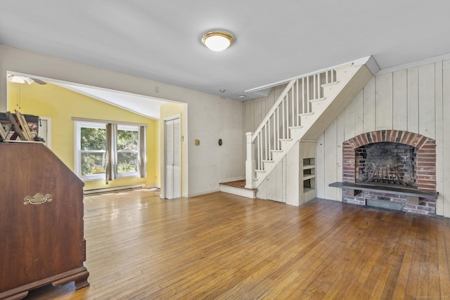 200 New Canaan Ave, Norwalk, CT 06850 - unfurnished living room featuring lofted ceiling, a brick fireplace, ceiling fan, stairway, and hardwood / wood-style flooring