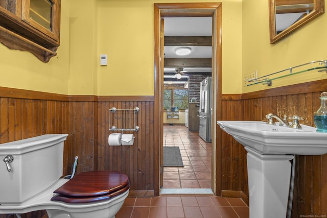 200 New Canaan Ave, Norwalk, CT 06850 - bathroom featuring a wainscoted wall, toilet, a ceiling fan, wood walls, and tile patterned flooring