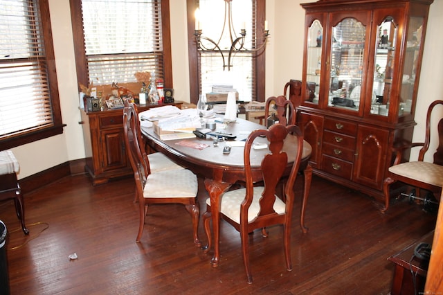 dining space with an inviting chandelier and dark wood finished floors