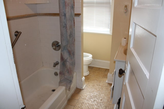 bathroom featuring vanity, shower / bath combo with shower curtain, toilet, and tile patterned flooring