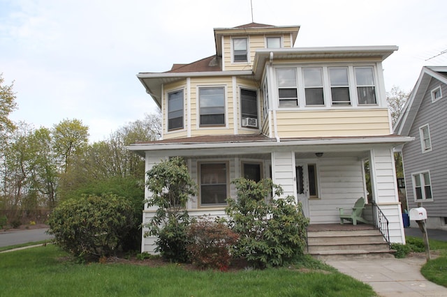american foursquare style home with a porch